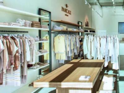 Chic clothing store with neat shelves and modern lighting.