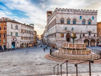 Historic square with fountain and medieval palace in Perugia.