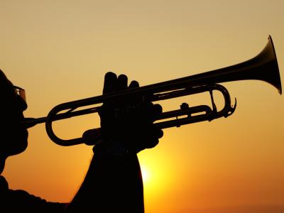 Silhouette of a trumpet player at sunset.