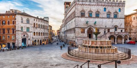 Historic square with fountain and medieval palace in Perugia.