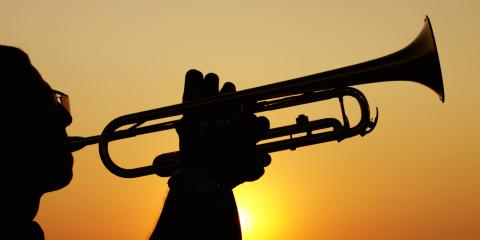 Silhouette of a trumpet player at sunset.