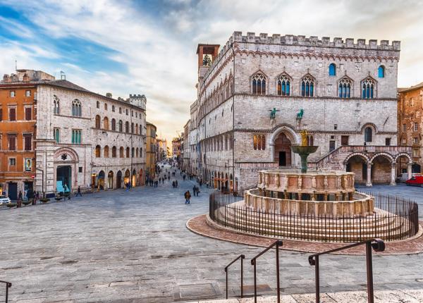 Historic square with fountain and medieval palace in Perugia.