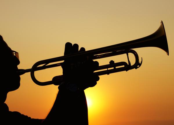 Silhouette of a trumpet player at sunset.